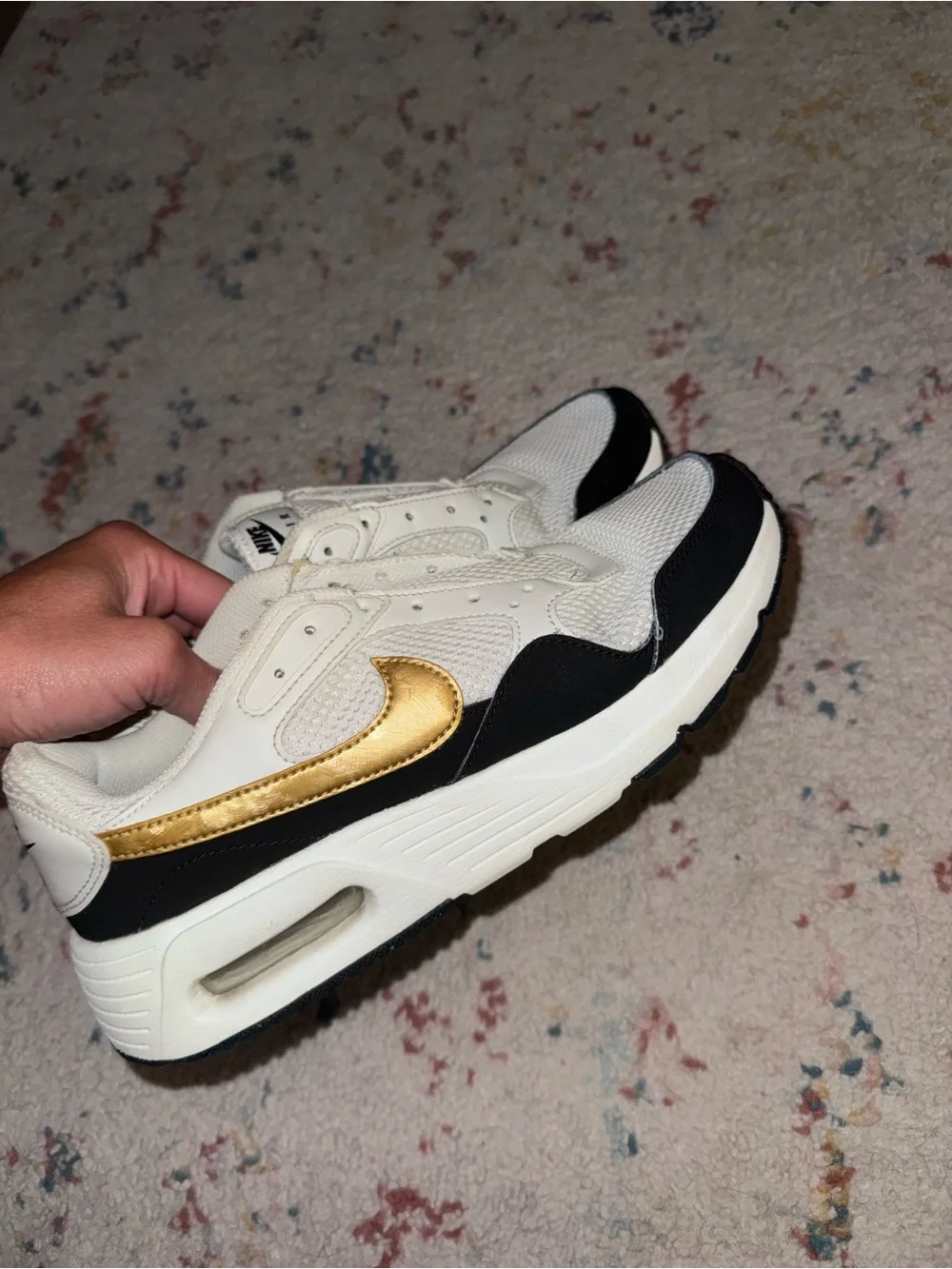 Nike White Sneakers with Black Trim and Gold Swoosh